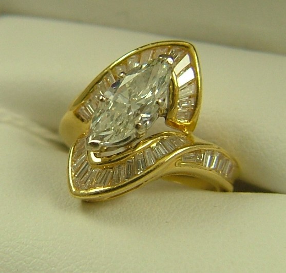 Appraisal: DIAMOND AND EIGHTEEN KARAT GOLD RING centering a marquise-cut diamond