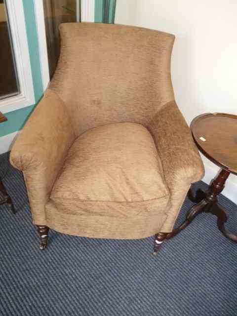 Appraisal: A BROWN DRAYLON UPHOLSTERED ARMCHAIR with turned feet