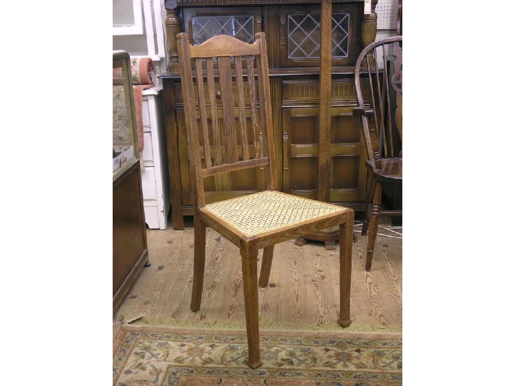 Appraisal: A set of four oak slat-back dining chairs with cane