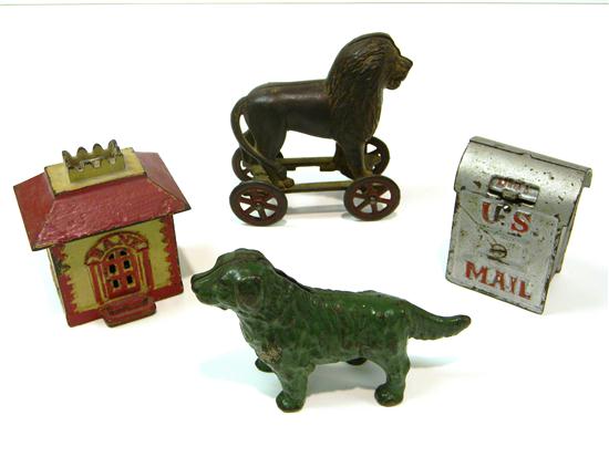 Appraisal: Four cast iron still banks standing lion on wheels U