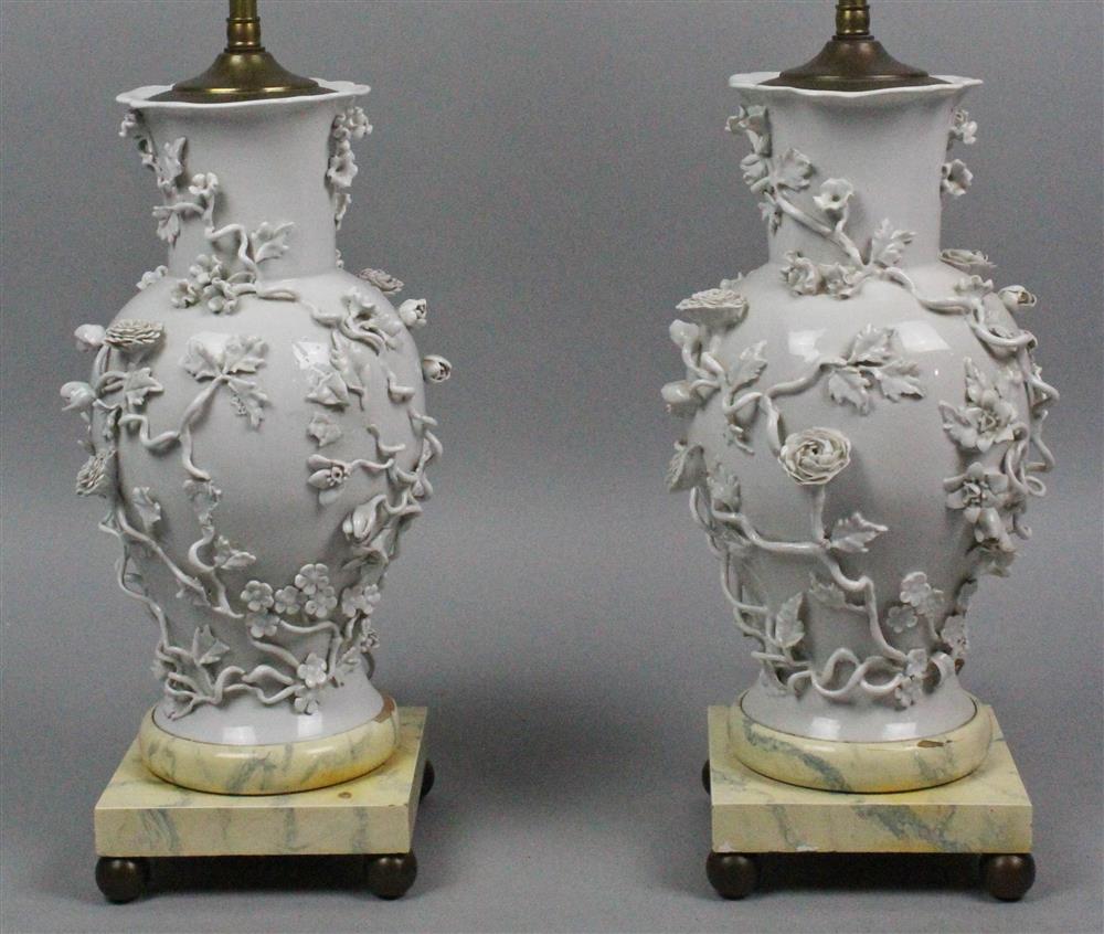 Appraisal: PAIR OF CONTINENTAL WHITE PORCELAIN FLOWER-ENCRUSTED TABLE LAMPS all atop