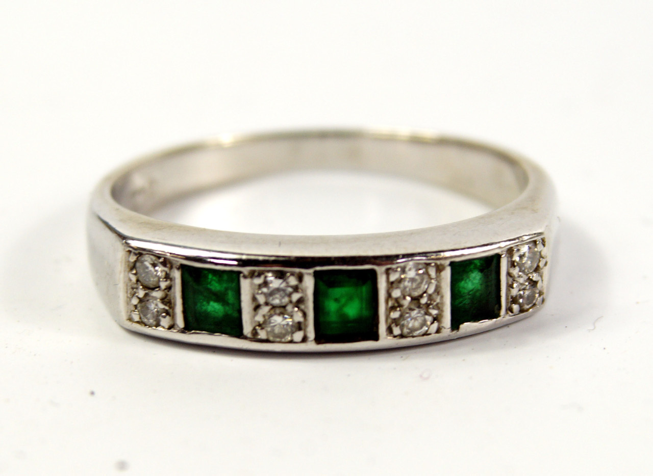 Appraisal: A emerald and diamond half hoop eternity ring set with