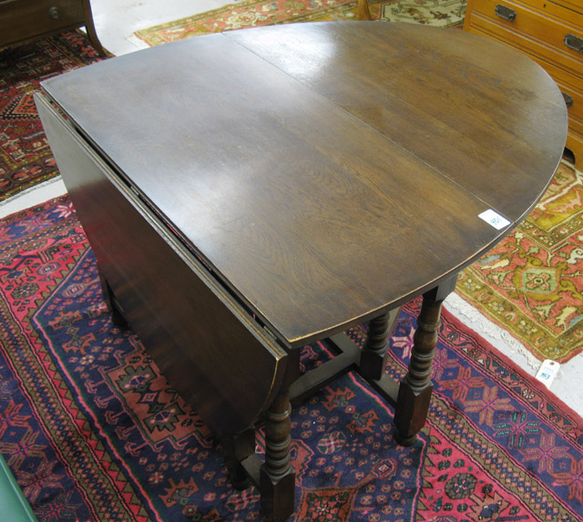 Appraisal: OAK DROP-LEAF GATE-LEG DINING TABLE English th century the demilune-shaped