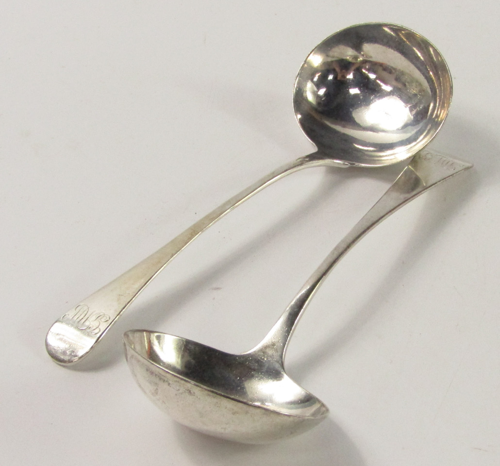 Appraisal: A pair of George III silver cream ladles monogram engraved