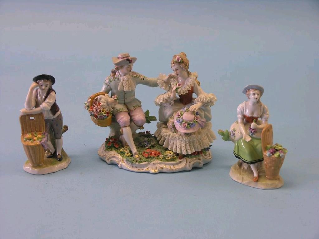 Appraisal: A Sitzendorf figure group seated male and female companion in