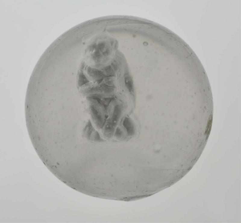 Appraisal: Chimpanzee Sulphide Marble Description Figure of chimpanzee sitting and holding