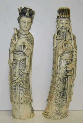 Appraisal: PAIR OF CHINESE CARVED IVORY FIGURES Standing depicting dignitary with