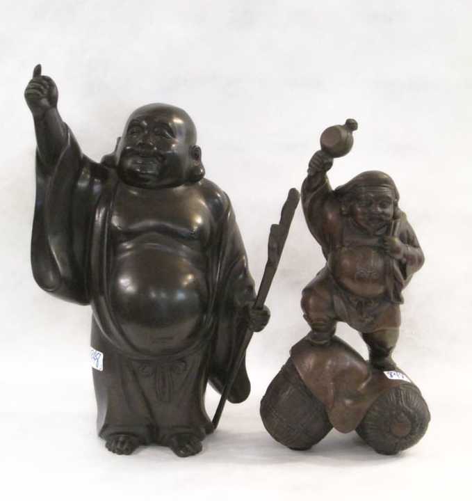 Appraisal: TWO ASIAN FIGURAL SCULPTURES one standing male with prayer wheal