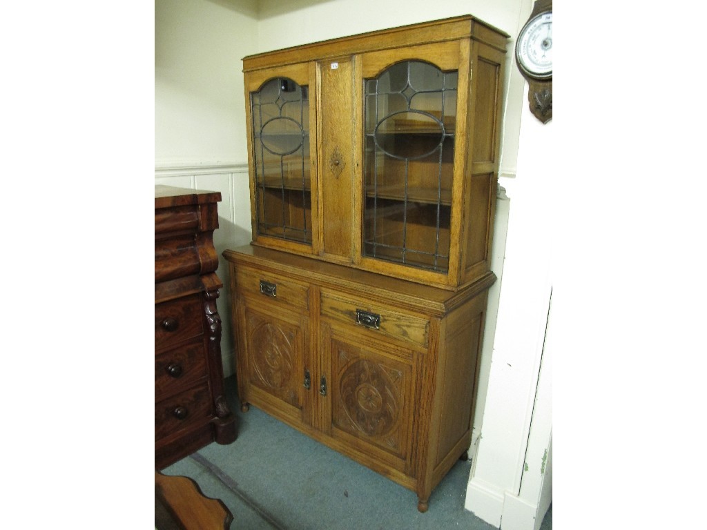 Appraisal: Edwardian oak glazed bookcase on cupboard base