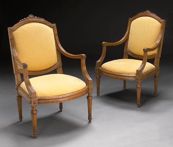 Appraisal: A pair of Louis XVI carved walnut fauteuils fourth quarter