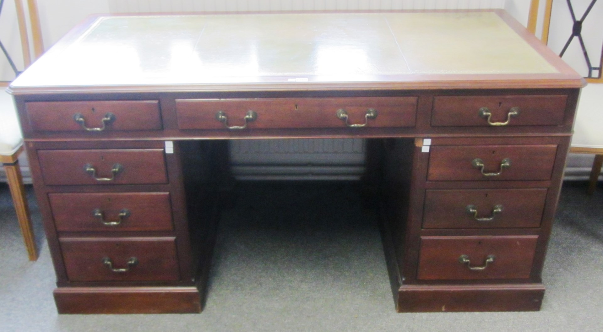 Appraisal: An th century style mahogany pedestal desk with nine frieze