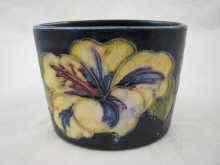 Appraisal: A blue Moorcroft oval pot a tube lined flower on