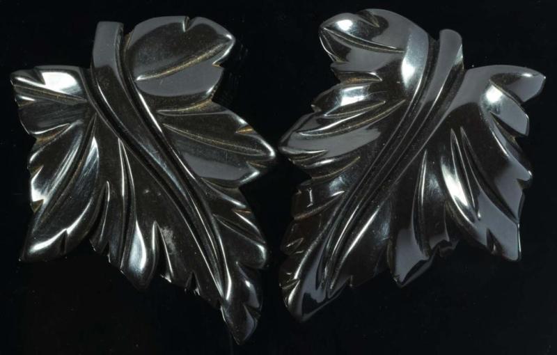 Appraisal: Pair of Bakelite Deeply Carved Black Floral Clips Condition Excellent