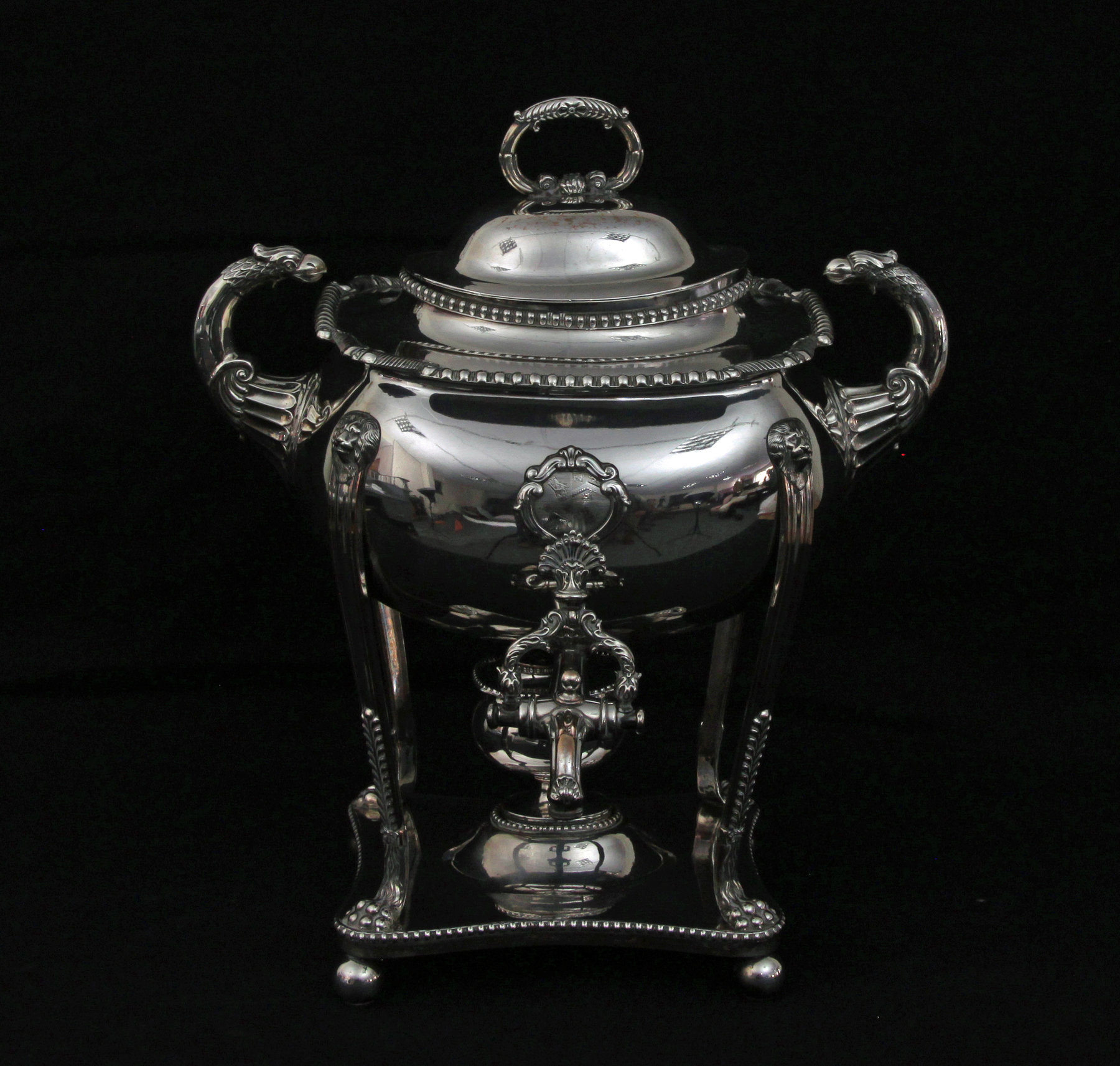 Appraisal: A large rectangular tea urn and cover with grotesque mask