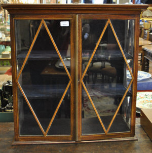 Appraisal: An Edwardian strung mahogany and satinwood cross-banded hanging small display