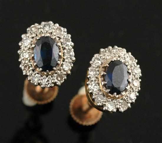 Appraisal: A pair of sapphire and diamond cluster earrings Centrally set