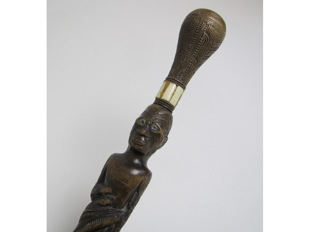 Appraisal: A Maori walking stick carved with a male figure above