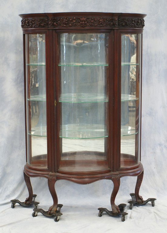 Appraisal: Figural and floral carved mahogany bowed glass crystal cabinet mirror