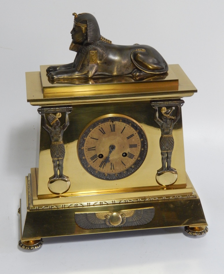 Appraisal: A thC gilt brass Egyptian Revival mantel clock with eight