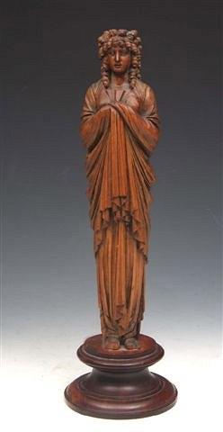 Appraisal: AN ITALIAN FRUITWOOD CARVING of a classical figure with flowing