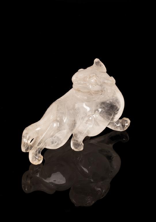 Appraisal: A CHINESE ROCK CRYSTAL BUDDHISTIC LION the striding beast with