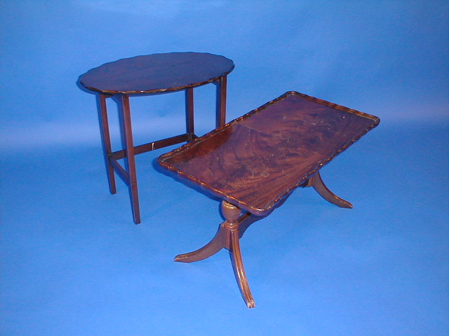 Appraisal: A reproduction flamed mahogany coffee table and another