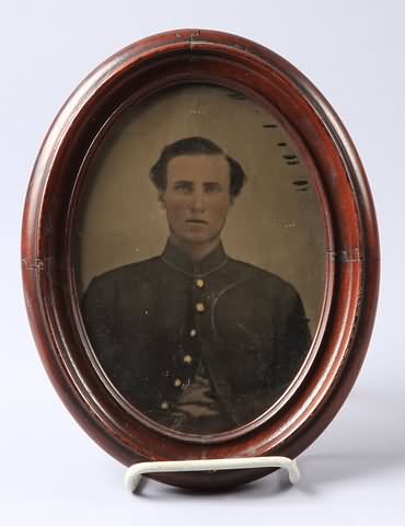 Appraisal: Large oval tintype of a Civil War soldier wearing nine-button