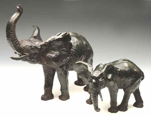 Appraisal: TWO TH CENTURY CAST IRON ELEPHANTS the largest wide