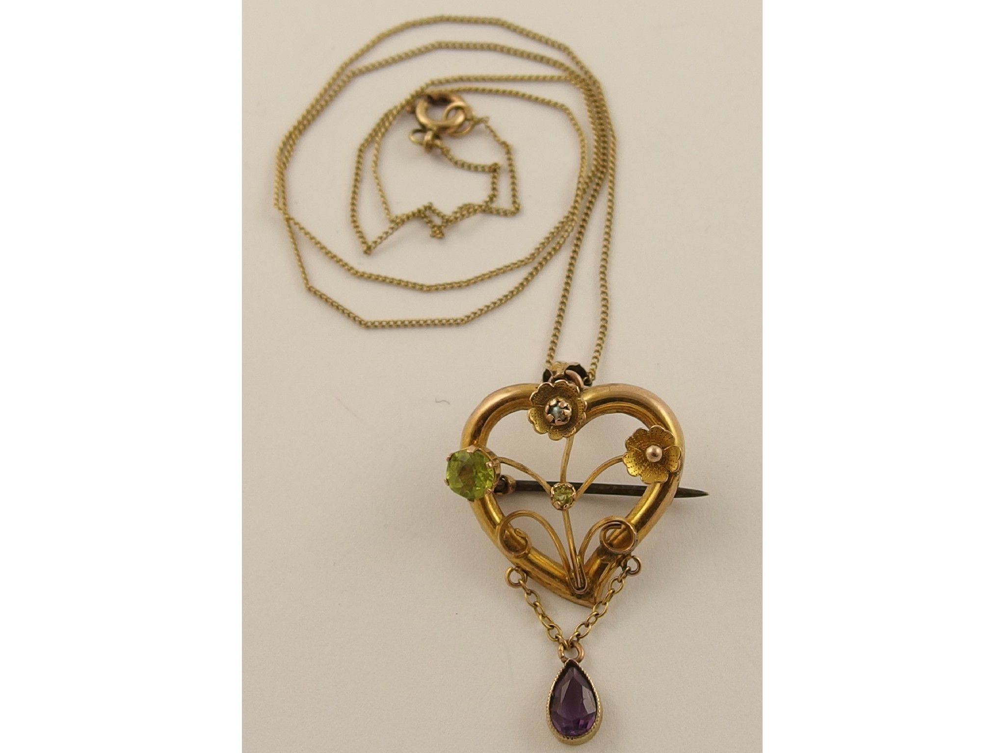 Appraisal: An Edwardian heart shaped pendant set with pearl peridot and