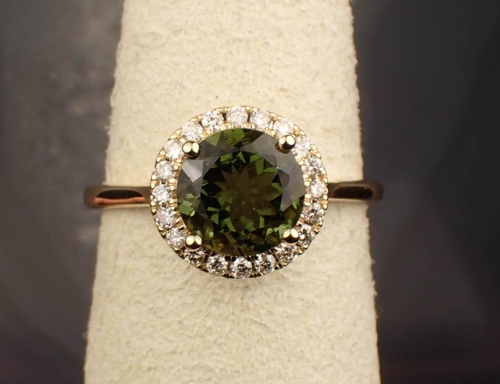 Appraisal: MOLDAVITE DIAMOND AND FOURTEEN KARAT GOLD RING The yellow gold