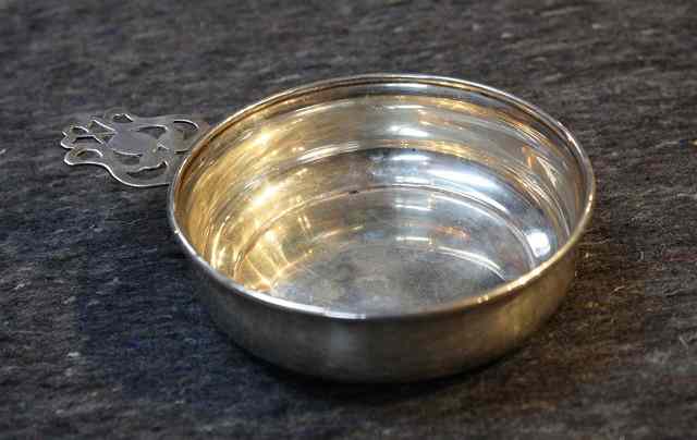 Appraisal: A SILVER PORRINGER with plain circular bowl and a single