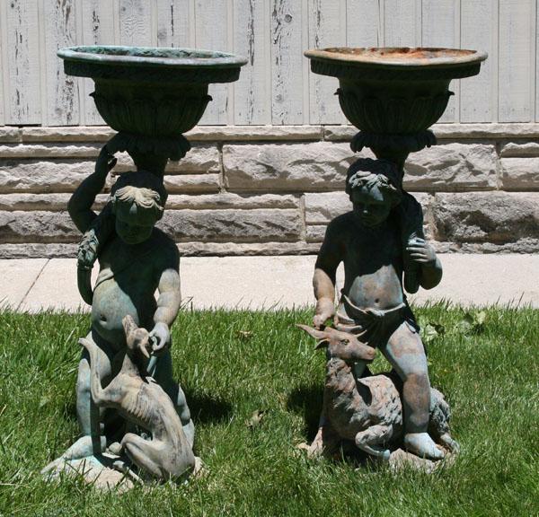 Appraisal: Cast metal urns garden statuary with floral patterned urns supported