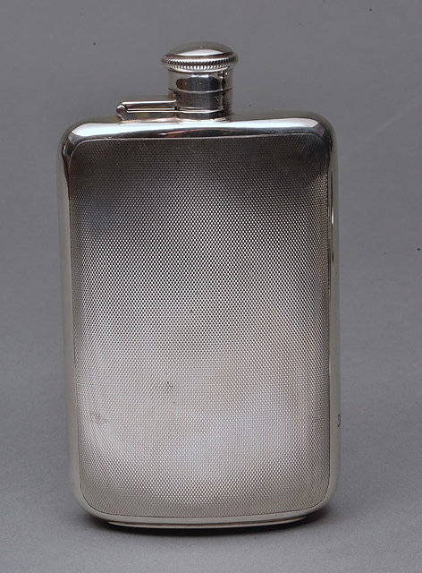 Appraisal: A LARGE SILVER HIP FLASK with hinged cap and engine