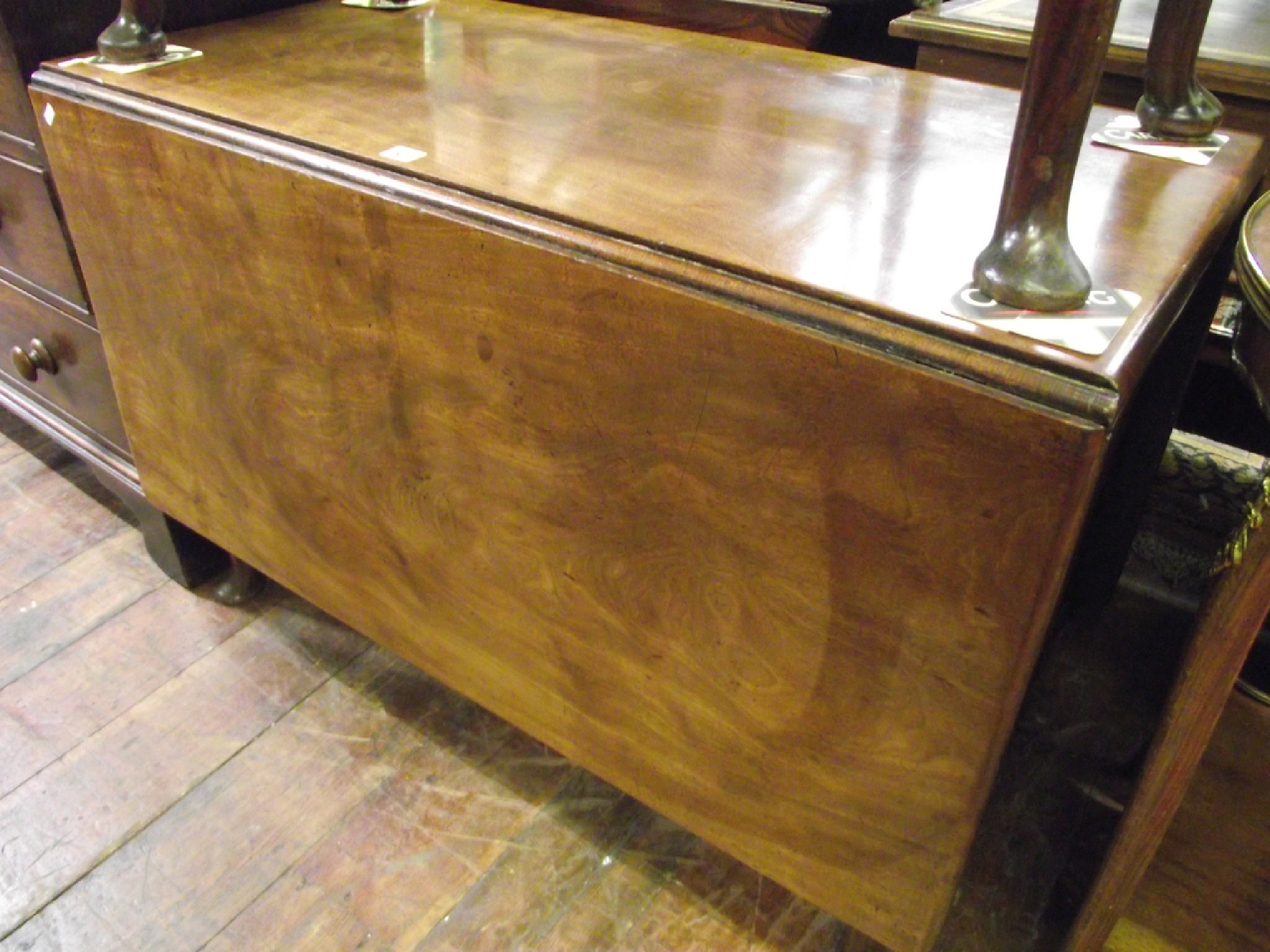 Appraisal: A large Georgian mahogany drop leaf dining table raised on