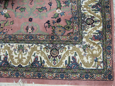 Appraisal: HAND KNOTTED ORIENTAL CARPET Indo-Persian floral design on rose pink