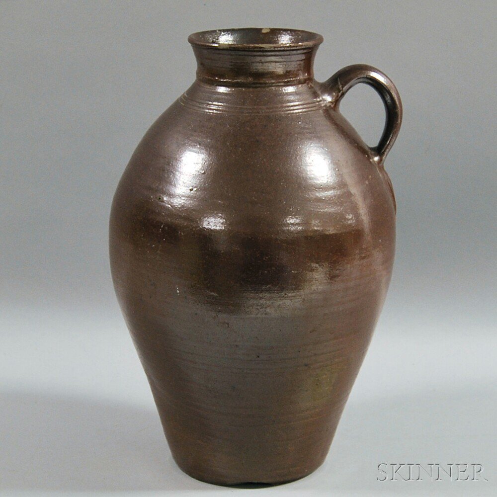 Appraisal: Large Brown-glazed Stoneware Jug America th century with incised lines