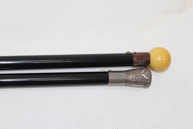 Appraisal: TWO EARLY TO MID TH CENTURY TAXI HALING STICKS to