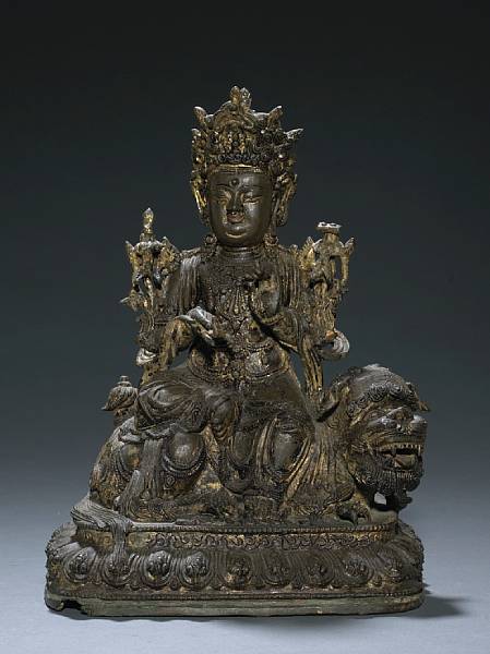 Appraisal: A bronze figure of Wenshu seated on a lion Ming