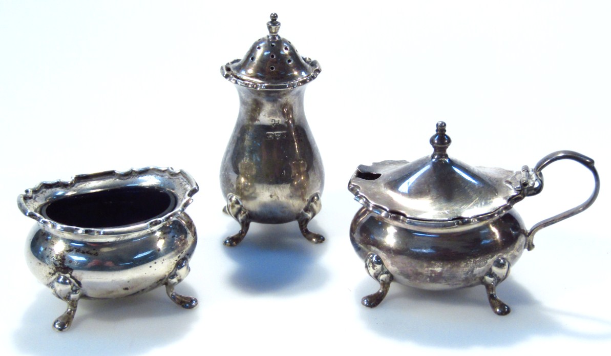 Appraisal: A George V silver three piece cruet set comprising pepper