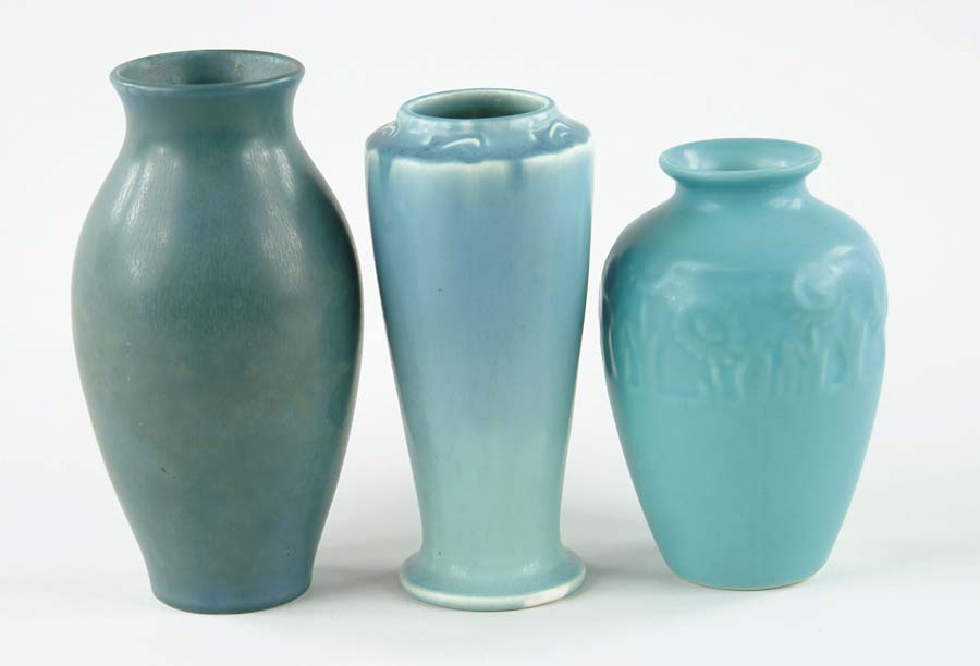 Appraisal: THREE ROOKWOOD VASES Matte blue vase has sunflower type design