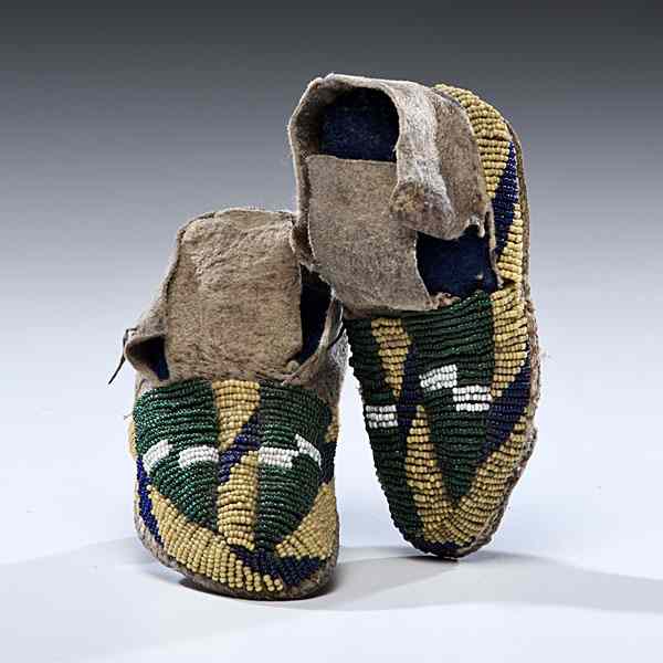 Appraisal: Sioux Child's Buffalo Hide Moccasins sinew-sewn and beaded using colors