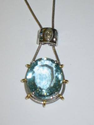 Appraisal: AN AQUAMARINE AND DIAMOND PENDANT the large oval cut aquamarine