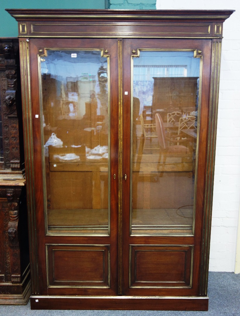 Appraisal: A th century French brass mounted mahogany glazed two door