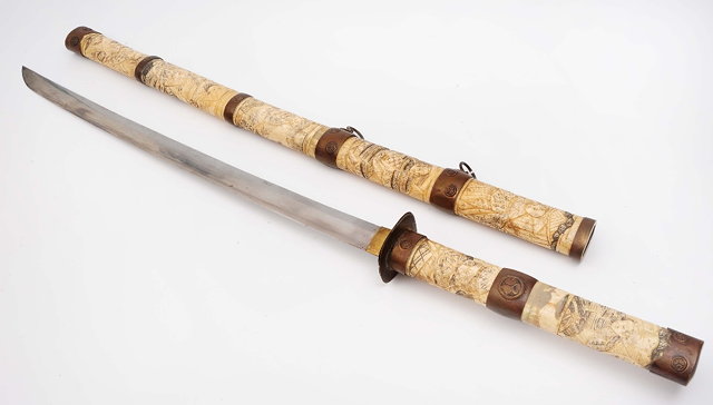 Appraisal: A Japanese Swordwith carved bone segmented hilt and scabbard depicting