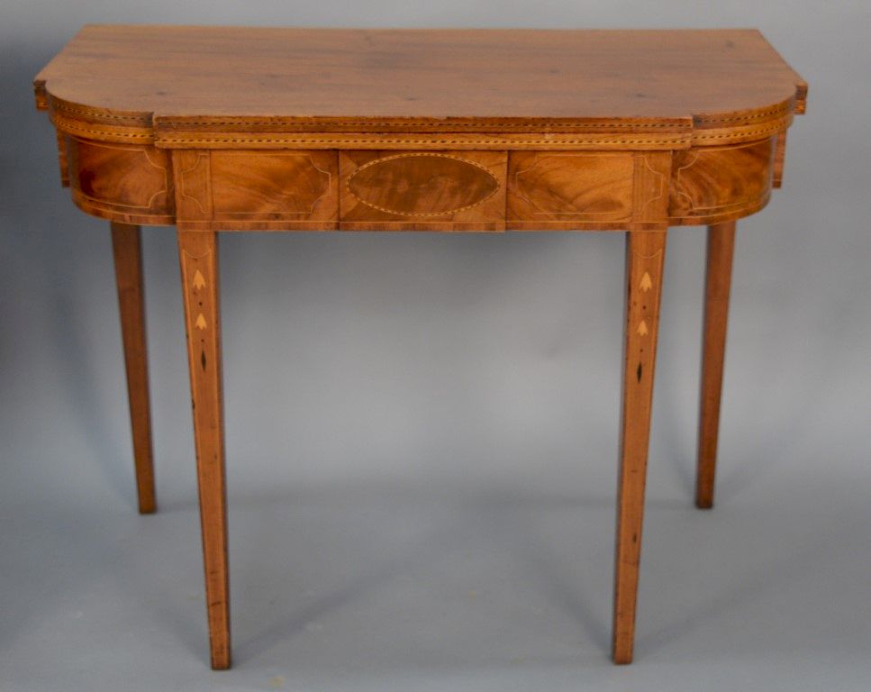 Appraisal: Federal mahogany D shaped game table with bellflower line and