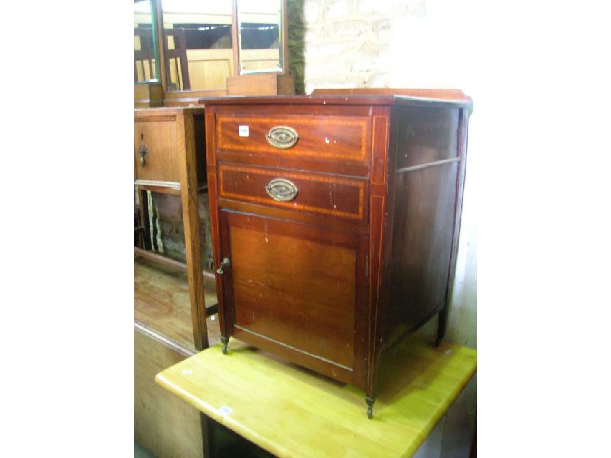 Appraisal: An inlaid Edwardian mahogany pedestal type chest fitted with two