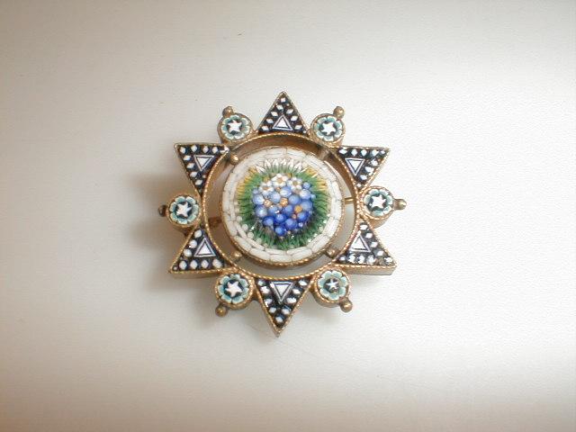 Appraisal: A six point star brooch with enamel points and a