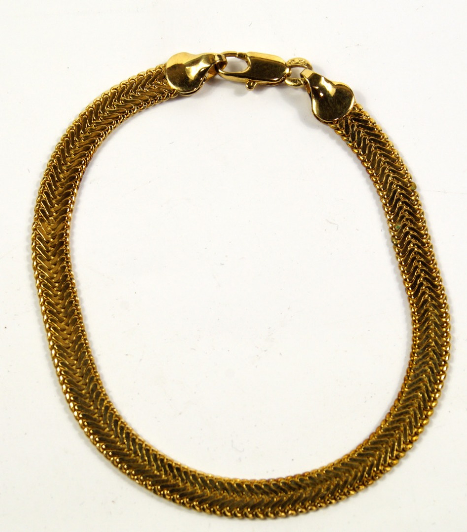 Appraisal: A herringbone link bracelet in yellow metal marked g