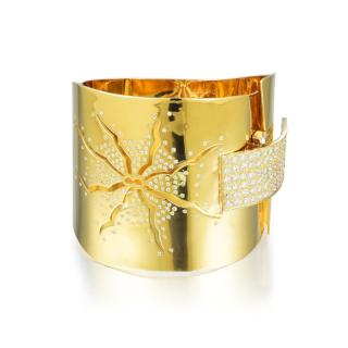 Appraisal: A Gold and Diamond Bangle Cuff Crafted out of brightly