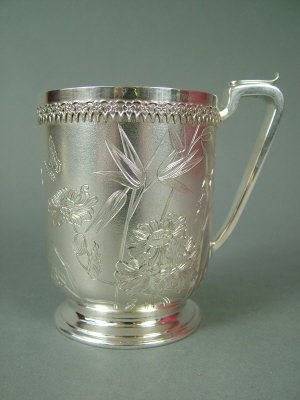 Appraisal: A Victorian silver christening mug engraved with peonies and bamboo